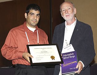 2005 Scholar Ozan Cakmakci receiving award from David Williamson